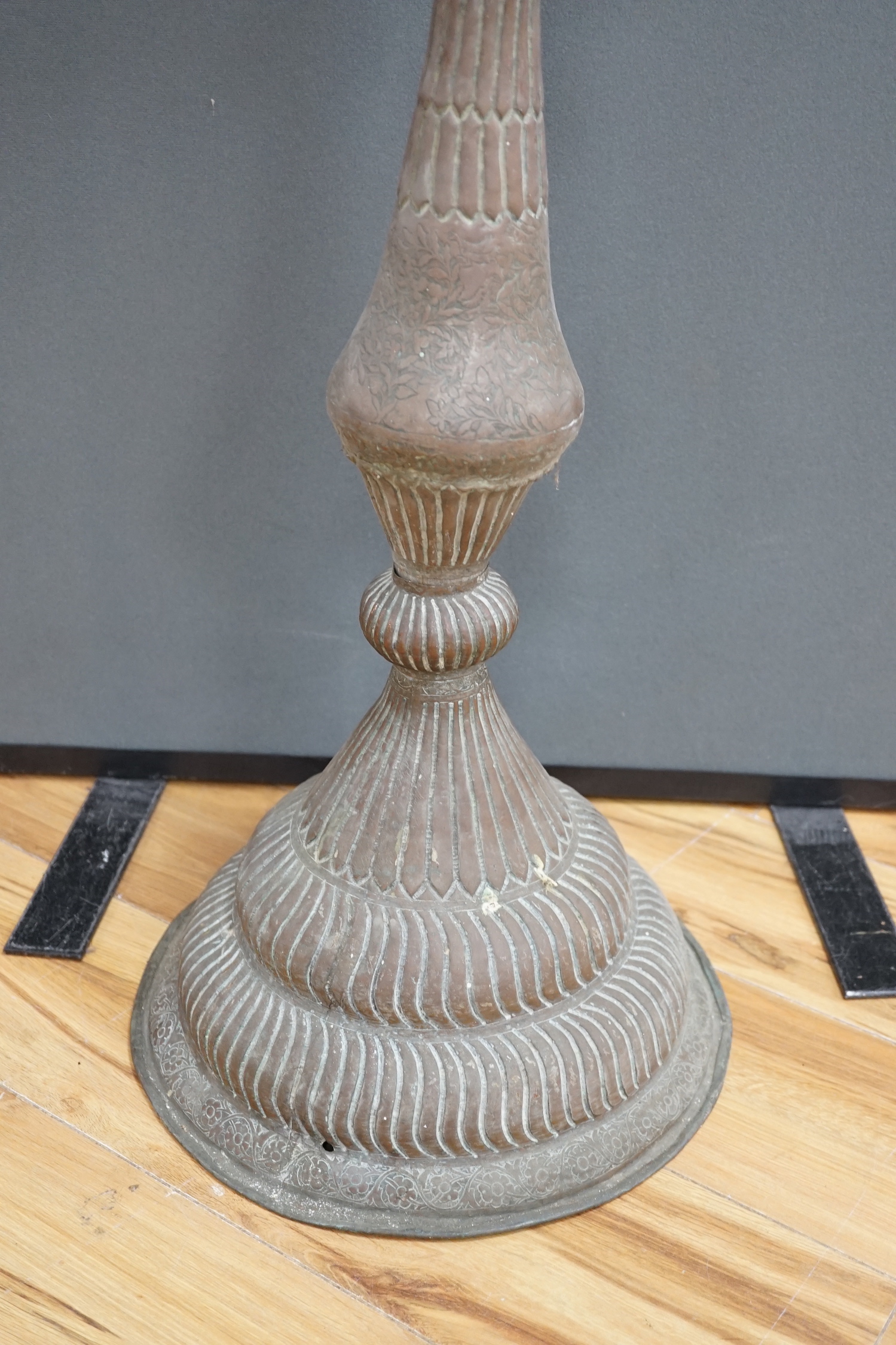 An Islamic copper candle stand, 19th/early 20th century, 97cm high